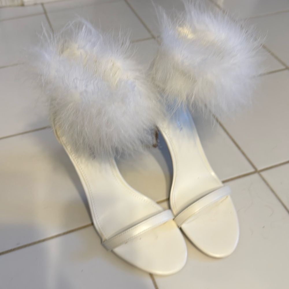 Beautiful white sandals with feathered ankle.